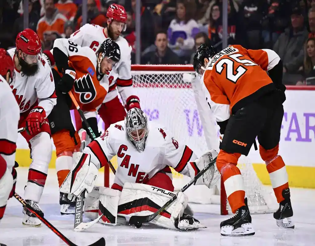 Carolina Hurricanes goalie blocks a shot from a Philadelphia Flyers player during their March 21, 2024 game