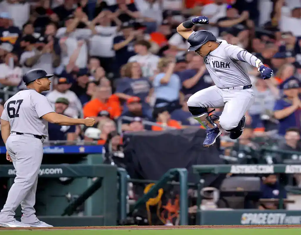 New York Yankees player celebrates after scoring a run during game against Arizona Diamondbacks