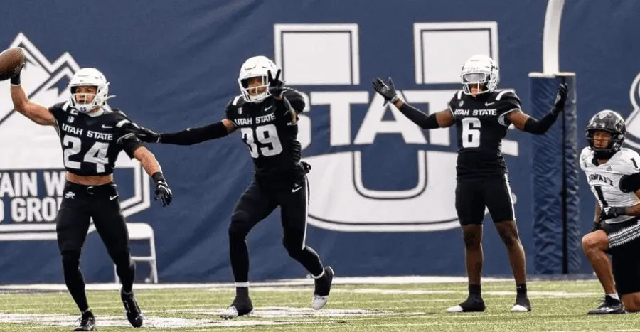 NCAAF 9 utah state players standing in a line
