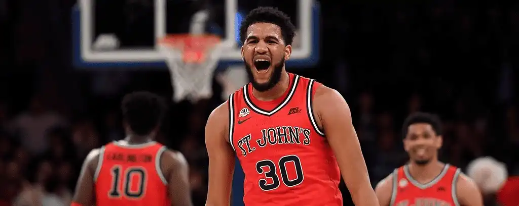 St. John's player wearing a celebrates on the court with a loud yell.