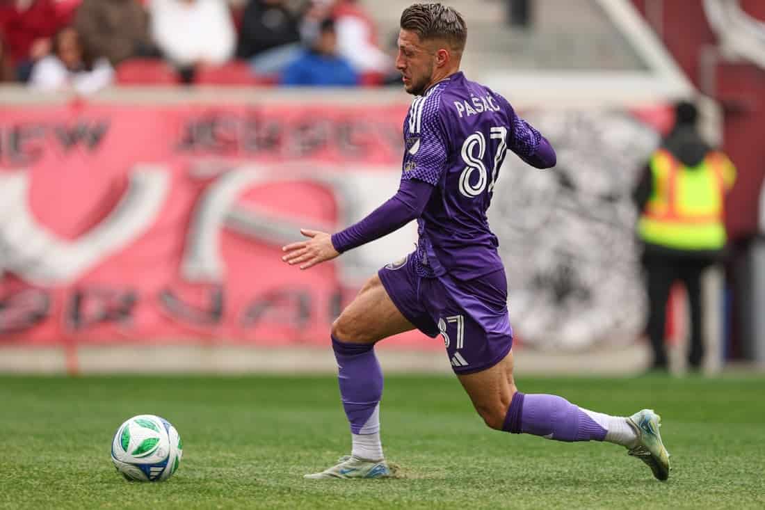 Orlando city Player dribbling past a player