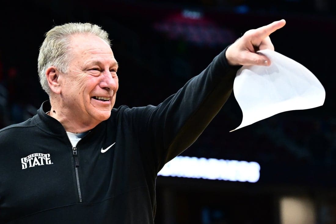 NCAAB Coach celebrating with his team