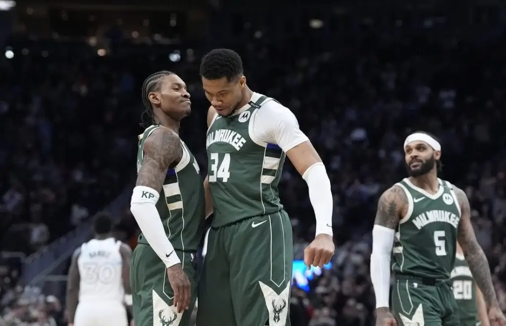 10 A group of Milwaukee Bucks players celebrate in their green jerseys during a basketball game, showcasing teamwork and excitement.