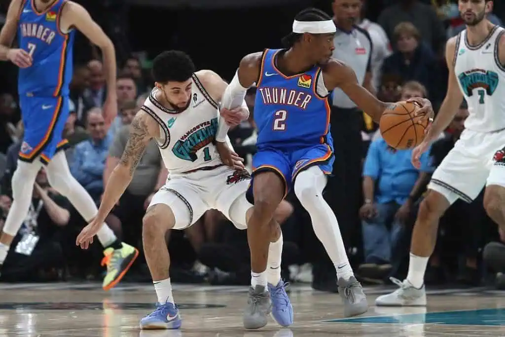 An intense basketball game scene, with players in action battling for the ball on the court, showcasing athleticism and teamwork.