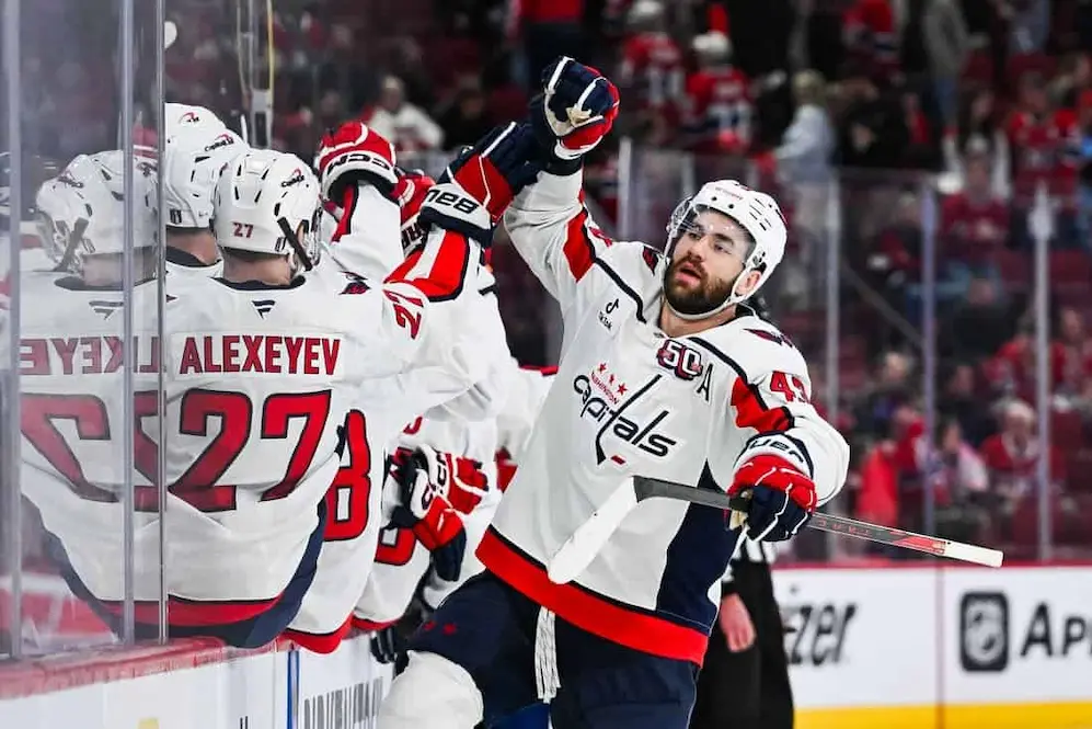 washington capitals player high fiving his teammates