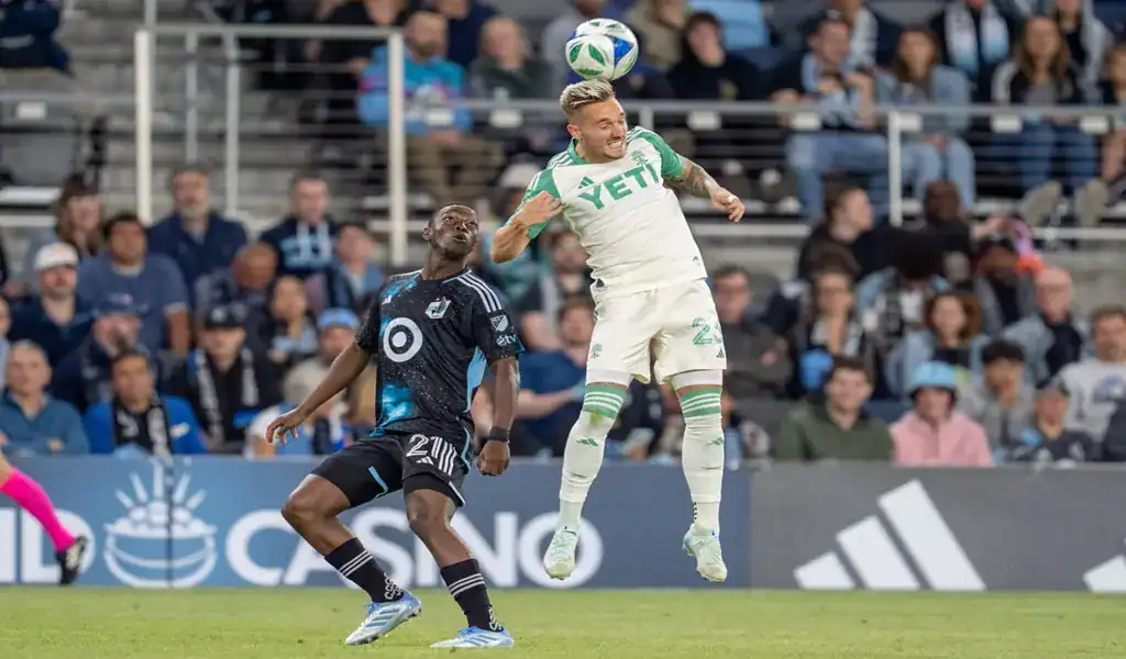 Austin FC player heads the ball during match against Real Salt Lake
