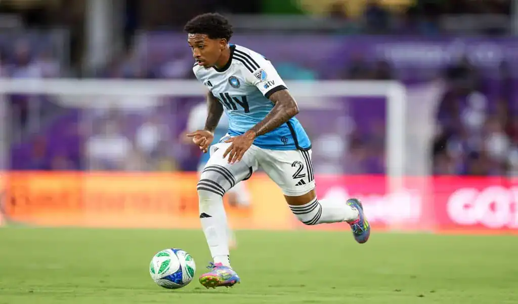 Charlotte FC player dribbles forward during MLS match against Toronto FC