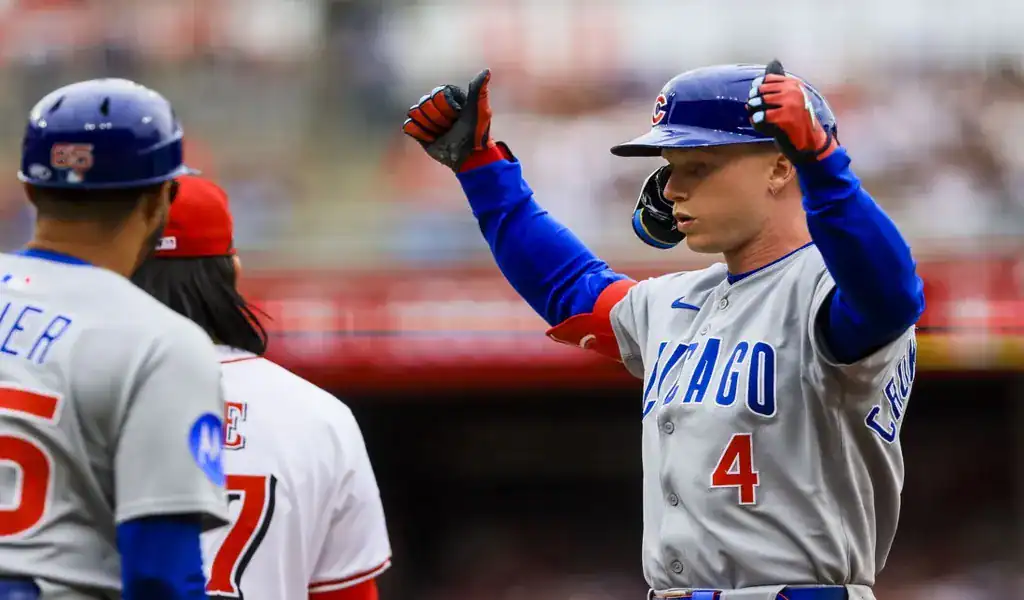Chicago Cubs player celebrates after reaching base against Rockies