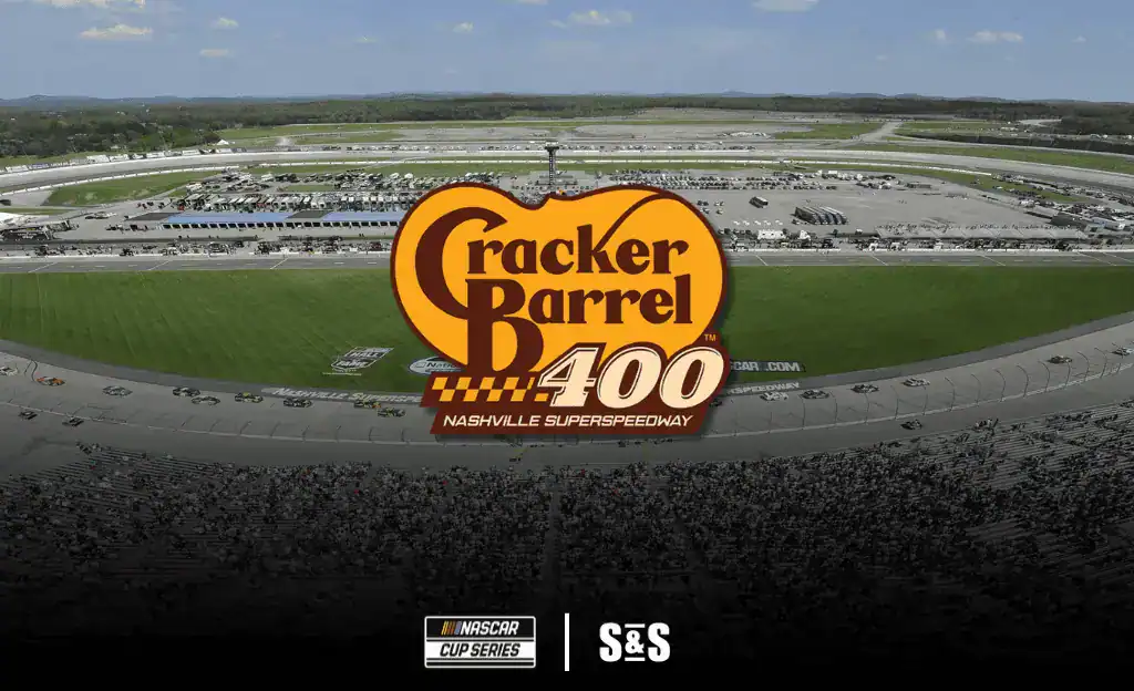 Aerial view of Nashville Superspeedway during the Cracker Barrel 400, featuring race cars on the track and a large crowd in the stands.