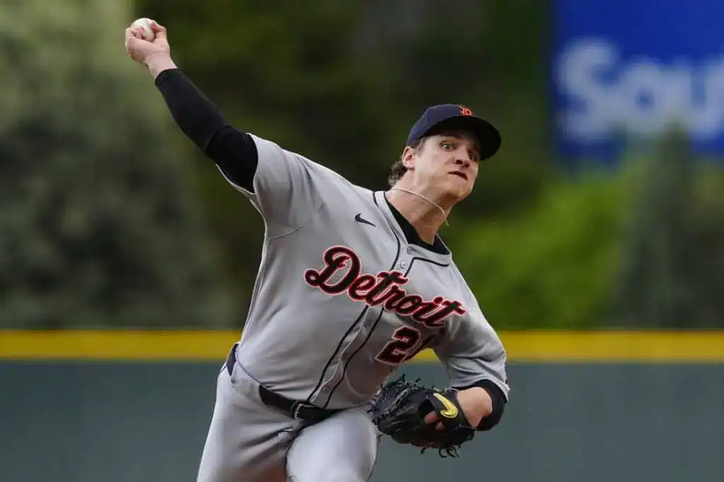 6 A Detroit baseball player in a gray uniform winds up to pitch on a field, showcasing focus and athleticism.