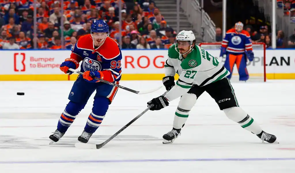 Edmonton Oilers and Dallas Stars players battle for puck in NHL playoff game