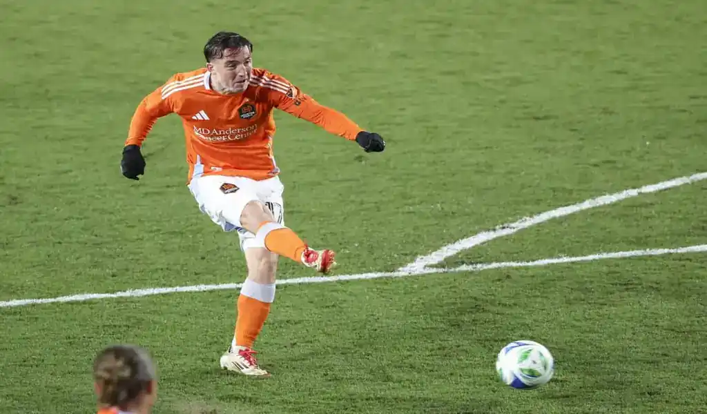 Houston Dynamo player kicks ball during match against Sporting Kansas City on May 31, 2025