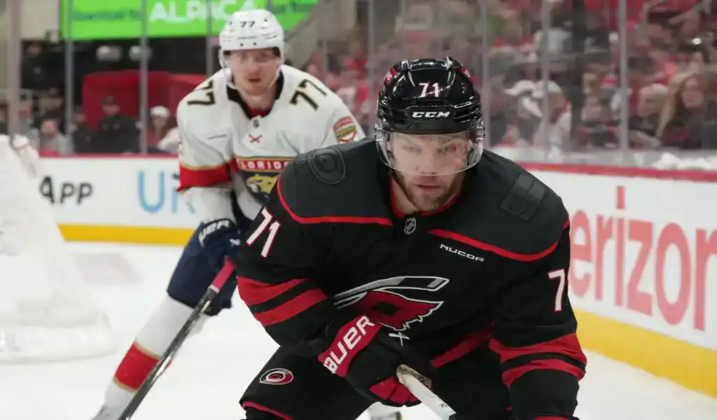 Carolina Hurricanes player handles the puck with Florida Panthers defender in pursuit during May 24, 2025 playoff game.