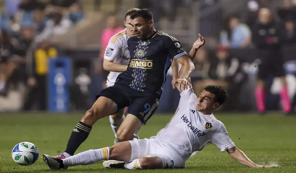 Philadelphia Union player dribbles past Toronto FC defender in MLS match