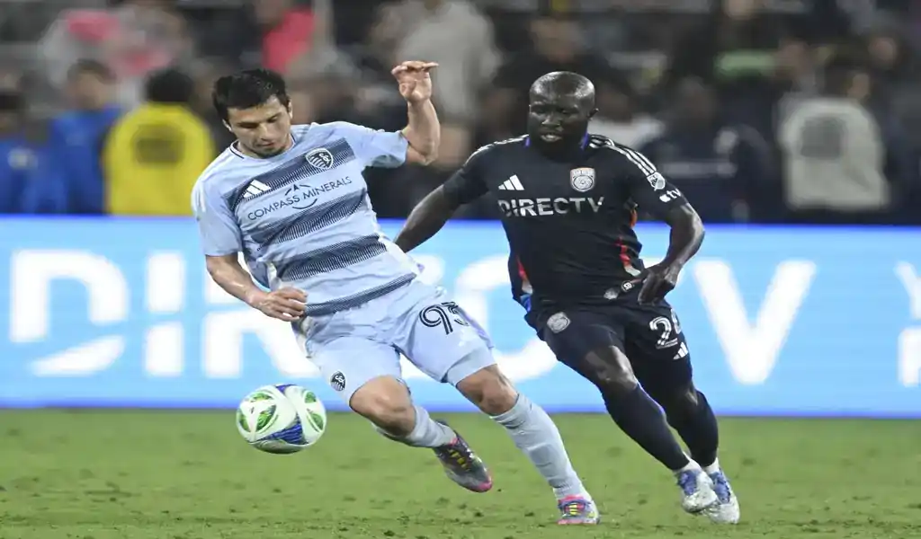Sporting Kansas City and New England Revolution players battle for the ball during MLS match on May 24, 2025.