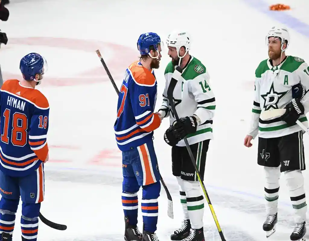 Edmonton Oilers and Dallas Stars players shake hands after their playoff game on May 21, 2025.
