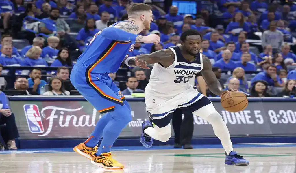 Minnesota Timberwolves player drives to the basket against Oklahoma City Thunder defender during May 24, 2025 playoff game.