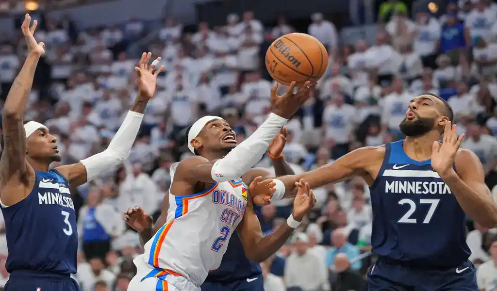 Oklahoma City Thunder player drives to the basket against Minnesota Timberwolves defenders on May 26, 2025.