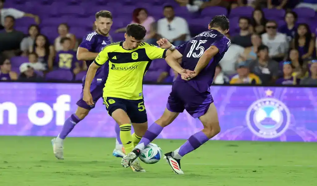 Nashville SC and Orlando City players fight for possession during May 24, 2025 match.