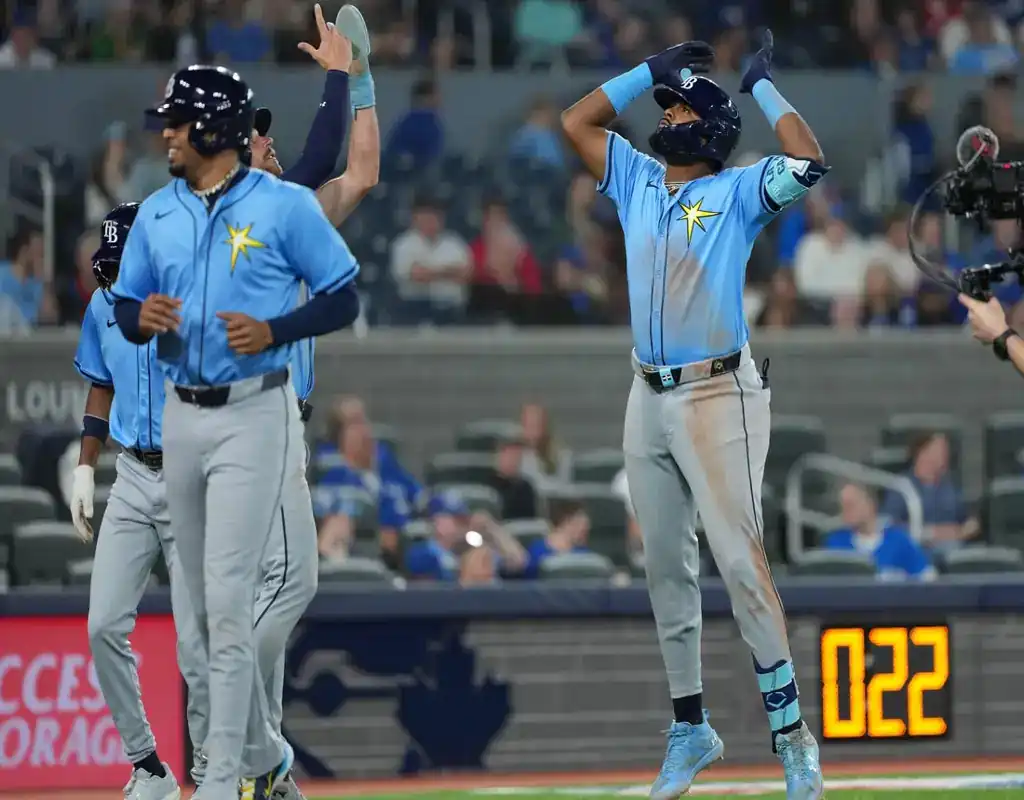 Tampa Bay Rays players celebrate after scoring during May 14, 2025 MLB game vs Toronto Blue Jays