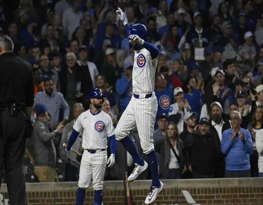 8 Chicago Cubs player celebrates scoring during May 13, 2025 MLB matchup vs Miami Marlins