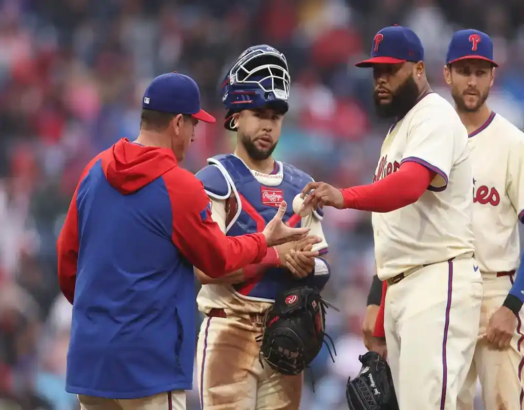 Philadelphia Phillies pitcher hands off the ball during mound visit against Colorado Rockies on May 19, 2025