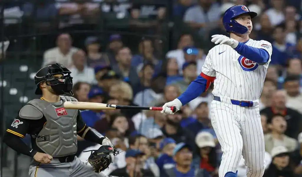 Chicago Cubs hitter watches his shot as Pirates catcher looks on