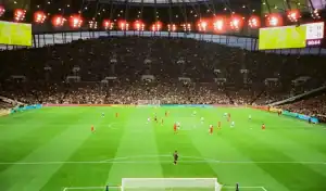 Premier League soccer match in a packed stadium, illustrating factors like wages, xG, and age curves guiding bookmakers