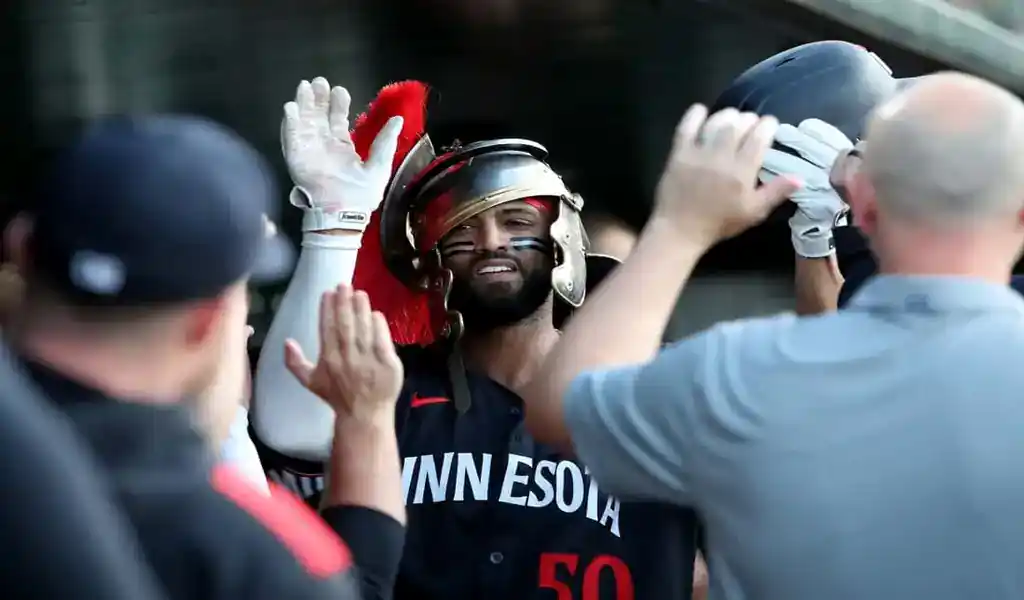 Minnesota Twins player celebrates in dugout wearing Roman helmet after play against Oakland Athletics on June 4, 2025