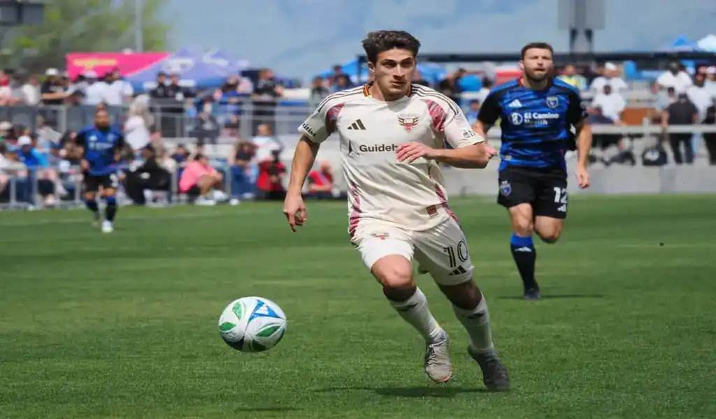 DC United player dribbles ball during game against Chicago Fire FC on June 7, 2025