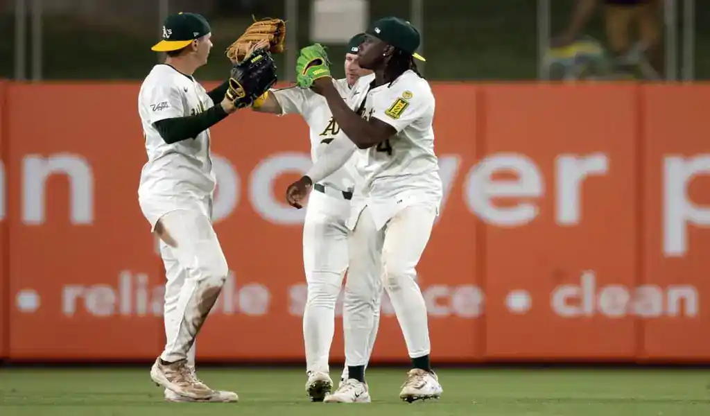 Oakland Athletics players celebrate on field during game against Baltimore Orioles on June 7, 2025